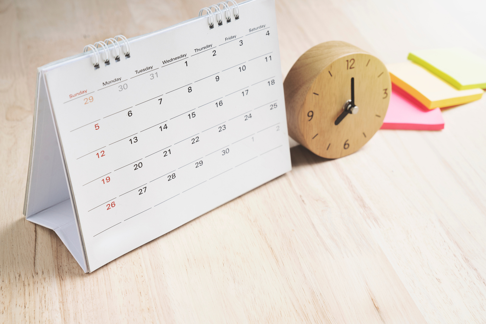 close up of calendar and clock on the table, planning for business meeting or travel planning concept