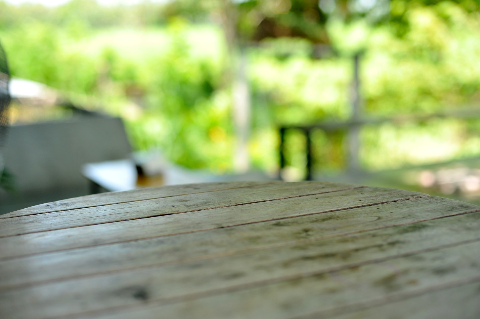 Empty Wood Table Top with Blur Garden Background 